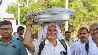 Polling officials carry EVMs as they leave for their respective polling stations on the eve of the Haryana Assembly elections, in Rohtak on Friday. (PTI) Polling officials carry EVMs as they leave for their respective polling stations on the eve of the Haryana Assembly elections, in Rohtak on Friday. (PTI)