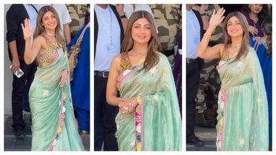Shilpa Shetty's outfit reminds us that festive styling can embrace any hue. Despite moving away from traditional warm tones, her cool-toned turquoise saree was stunning. The saree's borders featured an intricate pattern of colorful semicircles. (Instagram/@manavmanglani) Shilpa Shetty's outfit reminds us that festive styling can embrace any hue. Despite moving away from traditional warm tones, her cool-toned turquoise saree was stunning. The saree's borders featured an intricate pattern of colorful semicircles. (Instagram/@manavmanglani)