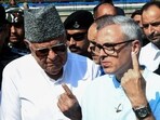 Jammu and Kashmir National Conference vice president and party candidate from Ganderbal and Budgam assembly seat Omar Abdullah with his father and party chief Farooq Abdullah. (ANI file)