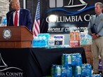 Republican presidential nominee former President Donald Trump speaks as Georgia Gov. Brian Kemp listens at a temporary relief shelter as he visits areas impacted by Hurricane Helene, Friday, Oct. 4, 2024, in Evans, Ga. AP/PTI(AP10_05_2024_000068A)