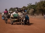 People with their belongings piled on a makeshift trailer pulled by two donkeys flee their villages amid a terror attack in Burkina Faso. People with their belongings piled on a makeshift trailer pulled by two donkeys flee their villages amid a terror attack in Burkina Faso.