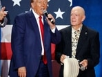 Republican presidential nominee former President Donald Trump accepts talks with a veteran identified as Dwight that gave Trump his purple heart after Trump was shot in Pennsylvania at a town hall event in Fayetteville, N.C., Friday, Oct. 4, 2024. (AP Photo/Karl B DeBlaker) Republican presidential nominee former President Donald Trump accepts talks with a veteran identified as Dwight that gave Trump his purple heart after Trump was shot in Pennsylvania at a town hall event in Fayetteville, N.C., Friday, Oct. 4, 2024. (AP Photo/Karl B DeBlaker)