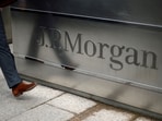 A man walks into the JP Morgan headquarters at Canary Wharf in London May 11, 2012.