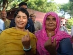 Congress candidate from Julana constituency Vinesh Phogat and her family member cast their votes at a polling station at Balali village during the Haryana Assembly elections, in Charkhi Dadri district
 (PTI Photo/Shahbaz Khan) 