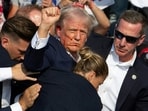 Republican candidate Donald Trump is seen with blood on his face surrounded by Secret Service agents as he is taken off the stage at a campaign event at Butler Farm Show Inc. in Butler, Pennsylvania, July 13, 2024. (Photo by Rebecca DROKE / AFP) Republican candidate Donald Trump is seen with blood on his face surrounded by Secret Service agents as he is taken off the stage at a campaign event at Butler Farm Show Inc. in Butler, Pennsylvania, July 13, 2024. (Photo by Rebecca DROKE / AFP)