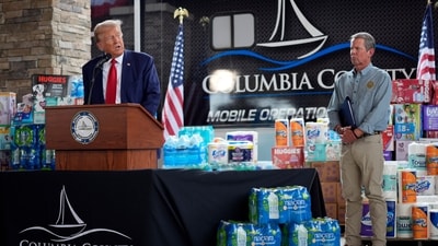 Republican presidential nominee former President Donald Trump speaks as Georgia Gov. Brian Kemp listens at a temporary relief shelter as he visits areas impacted by Hurricane Helene, Friday, Oct. 4, 2024, in Evans, Ga. AP/PTI(AP10_05_2024_000068A) (AP) Republican presidential nominee former President Donald Trump speaks as Georgia Gov. Brian Kemp listens at a temporary relief shelter as he visits areas impacted by Hurricane Helene, Friday, Oct. 4, 2024, in Evans, Ga. AP/PTI(AP10_05_2024_000068A) (AP)