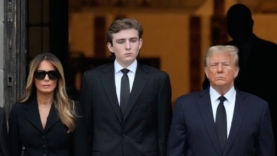 Former President Donald Trump, center right, stands with his wife Melania, second left, their son Barron, center left as the coffin carrying the remains of Amalija Knavs, the former first lady's mother, is carried into the Church of Bethesda-by-the-Sea for her funeral, Thursday, Jan. 18, 2024, in Palm Beach, Fla. (AP Photo/Rebecca Blackwell) (AP) Former President Donald Trump, center right, stands with his wife Melania, second left, their son Barron, center left as the coffin carrying the remains of Amalija Knavs, the former first lady's mother, is carried into the Church of Bethesda-by-the-Sea for her funeral, Thursday, Jan. 18, 2024, in Palm Beach, Fla. (AP Photo/Rebecca Blackwell) (AP)