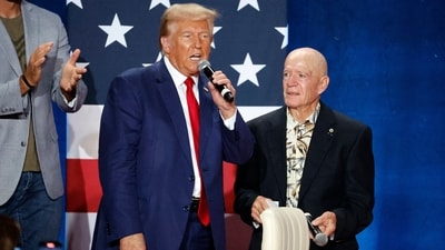 Republican presidential nominee former President Donald Trump accepts talks with a veteran identified as Dwight that gave Trump his purple heart after Trump was shot in Pennsylvania at a town hall event in Fayetteville, N.C., Friday, Oct. 4, 2024. (AP Photo/Karl B DeBlaker) (AP) Republican presidential nominee former President Donald Trump accepts talks with a veteran identified as Dwight that gave Trump his purple heart after Trump was shot in Pennsylvania at a town hall event in Fayetteville, N.C., Friday, Oct. 4, 2024. (AP Photo/Karl B DeBlaker) (AP)