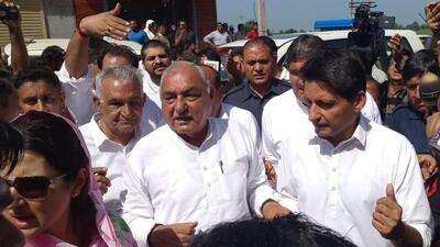Former chief minister and Congress leader Bhupinder Singh Hooda, his son and party MP Deepender Hooda after casting their vote in Rohtak on Saturday. (Manoj Dhaka/HT)