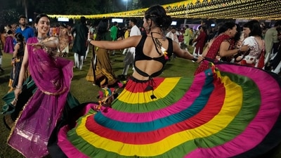 A woman pulls off a beautiful dance move during Garba night. (AP) A woman pulls off a beautiful dance move during Garba night. (AP)