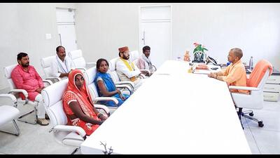 UP CM Yogi Adityanath meeting Amethi victms’ kin at his residence in Lucknow on Saturday. (ANI)