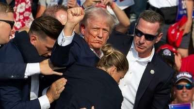 Donald Trump was hit in the ear in an apparent assassination attempt by a gunman at a campaign rally on Saturday, in a chaotic and shocking incident that will fuel fears of instability ahead of the 2024 US presidential election. (Photo by Rebecca DROKE / AFP) Donald Trump was hit in the ear in an apparent assassination attempt by a gunman at a campaign rally on Saturday, in a chaotic and shocking incident that will fuel fears of instability ahead of the 2024 US presidential election. (Photo by Rebecca DROKE / AFP)