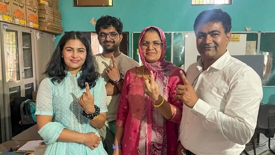 Jhajjar: Paris Olympics medallist shooter Manu Bhaker and her family members show their fingers marked with indelible ink after casting vote at a polling station during the Haryana Assembly elections, in Jhajjar, Saturday, Oct. 5, 2024. (PTI Photo)