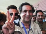 Jammu and Kashmir People’s Conference president Sajad Gani Lone shows a victory sign after casting his vote.





