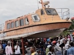 Residents gather to witness the search and rescue mission after a boat ferrying passengers and goods sank in Congo.