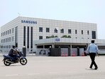 Samsung plant protests: A motorcyclist rides past Samsung company plant in Sriperumbudur, on the outskirts of Chennai.