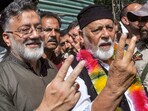 People's Conference leader and Shia cleric Imran Reza Ansari (L) shows victory sign.