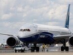 Boeing employees walk the new Boeing 787-10 Dreamliner down towards the delivery ramp area at the company's facility.