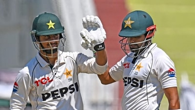 Pakistan's Saim Ayub (L) after scoring a half-century with teammate Babar Azam during a Test against Bangladesh (AFP)