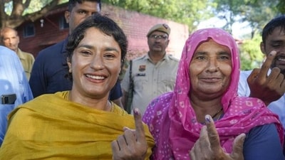 Congress candidate from Julana Vinesh Phogat and her mother Premlata after casting their votes. (PTI Photo) Congress candidate from Julana Vinesh Phogat and her mother Premlata after casting their votes. (PTI Photo)