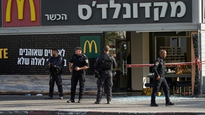 Police officers examine the scene of a stabbing and shooting attack where Israel's Magen David Adom rescue service said one person was killed and several others were wounded in Beersheba, Israel, Sunday, Oct. 6, 2024. (AP)