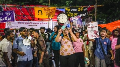 Kolkata: Junior doctors stage a protest against the alleged rape and murder of their colleague at the RG Kar hospital at their sit-in site, in Kolkata. (PTI) Kolkata: Junior doctors stage a protest against the alleged rape and murder of their colleague at the RG Kar hospital at their sit-in site, in Kolkata. (PTI)