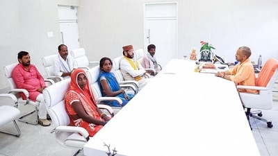 UP CM Yogi Adityanath meeting Amethi victms’ kin at his residence in Lucknow on Saturday. (ANI)