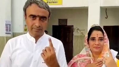 Anurag Dhanda and his wife Jyoti Sandhu show their ink-marked fingers after casting their votes for the Haryana Assembly elections, in Kaithal. (ANI)
