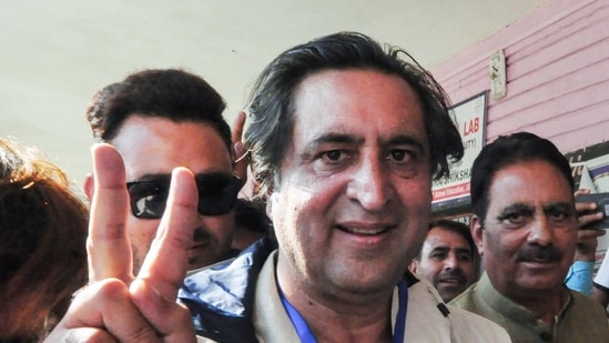 Jammu and Kashmir People’s Conference president Sajad Gani Lone shows a victory sign after casting his vote. (ANI )