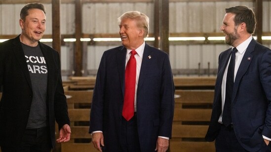 Former US President Donald Trump, center, and Senator JD Vance, right, a Republican from Ohio and Republican vice-presidential nominee, greet Elon Musk, chief executive officer of Tesla Inc., backstage prior to a campaign event at the Butler Farm Show in Butler, Pennsylvania, US, on Saturday, Oct. 5, 2024. Elon Musk will campaign with the former president on Saturday, joining a rally at the scene of a summer assassination attempt and cementing his role as one of the Republican candidate's key backers. Photographer: Justin Merriman/Bloomberg (Bloomberg)