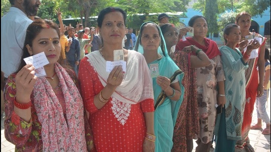 Voters waiting for their turn at Abheypur village in Panchkula on Saturday. (Sant Arora/HT)