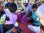 A woman being evacuated from a huge rush at the air show in Chennai.