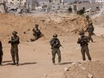 Israel-Iran conflict live updates: Israeli soldiers stand guard as damaged buildings are seen in the background, amid the ongoing war with Hamas and Hezbollah.