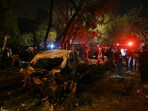 Security officials examine at the site of an explosion which occurred near Karachi airport in Karachi, on late October 6, 2024. A massive blast rocked a road near the airport of Pakistan's largest city as a separatist militant group claimed on Monday an attack in the area.