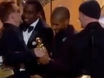 While Bono was looking pleased with himself as he accepted his trophy from Usher, Diddy approached him to give a congratulatory hug.