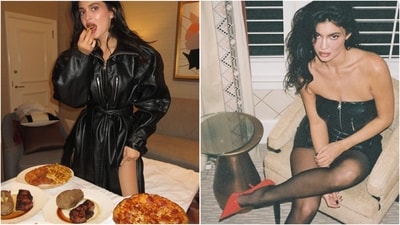 Kylie Jenner recently rocked a stunning black off-shoulder mini dress layered with an overcoat. Paired with black stockings and bold red pump heels, she exudes glamour effortlessly. (Instagram)