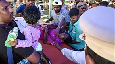 A woman being evacuated from a huge rush at the air show in Chennai. (ANI) A woman being evacuated from a huge rush at the air show in Chennai. (ANI)