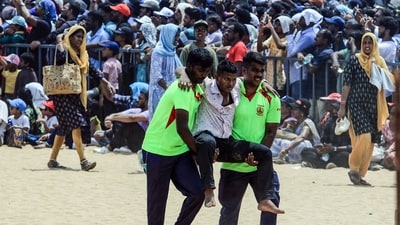 Tamil Nadu Fire and Rescue Service personnel evacuate a man after he fainted due to heat during the Indian Air Force air show. Tamil Nadu Fire and Rescue Service personnel evacuate a man after he fainted due to heat during the Indian Air Force air show.
