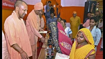Chief minister Yogi Adityanath distributes sewing machines to women during Durga Puja festivities, in Varanasi, Monday. (PTI Photo) Chief minister Yogi Adityanath distributes sewing machines to women during Durga Puja festivities, in Varanasi, Monday. (PTI Photo)