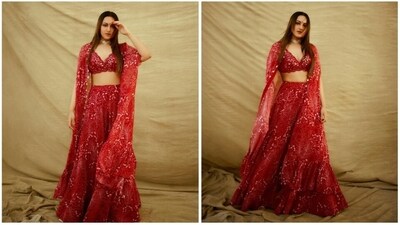 Sonakshi Sinha's Navratri edition red lehenga set is the perfect inspiration to go bold with colors this festive season. Featuring an embellished bralette, printed cape, and palazzo pants, she effortlessly aces ethnic fashion with a modern twist. (Instagram/@aslisona) Sonakshi Sinha's Navratri edition red lehenga set is the perfect inspiration to go bold with colors this festive season. Featuring an embellished bralette, printed cape, and palazzo pants, she effortlessly aces ethnic fashion with a modern twist. (Instagram/@aslisona)