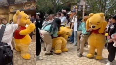 Winnie the Pooh mascot collapses after being hit on head by tourist at Shanghai Disneyland. (X) Winnie the Pooh mascot collapses after being hit on head by tourist at Shanghai Disneyland. (X)