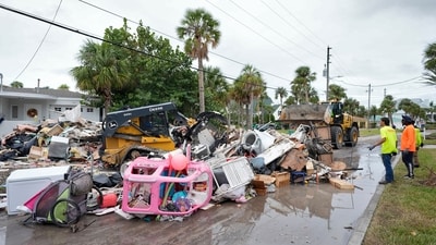 Salvage works remove debris from Hurricane Helene flooding along the Gulf of Mexico before approaching Milton, Monday, Oct. 7, 2024, in Clearwater Beach, Fla. (AP Photo/Chris O'Meara) (AP) Salvage works remove debris from Hurricane Helene flooding along the Gulf of Mexico before approaching Milton, Monday, Oct. 7, 2024, in Clearwater Beach, Fla. (AP Photo/Chris O'Meara) (AP)