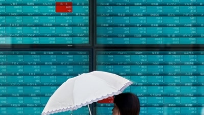 A woman walks in front of an electronic quotation board displaying stock prices of Nikkei 225 on the Tokyo Stock Exchange in Tokyo. (AFP) A woman walks in front of an electronic quotation board displaying stock prices of Nikkei 225 on the Tokyo Stock Exchange in Tokyo. (AFP)