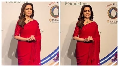 Nita Ambani's six yards of elegance is the perfect Navratri outfit inspiration for Day 6. Her red saree, adorned with sequin borders and paired with a matching elbow-length sleeves blouse, exudes glamour. (Instagram/@manavmanglani) Nita Ambani's six yards of elegance is the perfect Navratri outfit inspiration for Day 6. Her red saree, adorned with sequin borders and paired with a matching elbow-length sleeves blouse, exudes glamour. (Instagram/@manavmanglani)