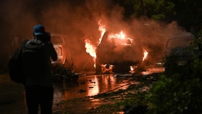 A news cameraman shoots a burning car at the site of an explosion which occured near Karachi airport in Karachi, on late October 6, 2024. (AFP) A news cameraman shoots a burning car at the site of an explosion which occured near Karachi airport in Karachi, on late October 6, 2024. (AFP)