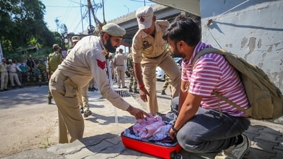Jammu: Security personnel check luggage of a commuter outside a counting centre, a day before the counting of votes for Jammu & Kashmir Assembly elections, in Jammu, Monday, Oct. 7, 2024. (PTI) Jammu: Security personnel check luggage of a commuter outside a counting centre, a day before the counting of votes for Jammu & Kashmir Assembly elections, in Jammu, Monday, Oct. 7, 2024. (PTI)