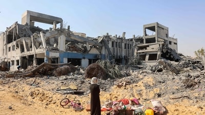A woman looks around as she salvages items at the damaged UN Relief and Works Agency for Palestine Refugees building complex in western Gaza City's Al-Sinaa. (AFP) (AFP) A woman looks around as she salvages items at the damaged UN Relief and Works Agency for Palestine Refugees building complex in western Gaza City's Al-Sinaa. (AFP) (AFP)