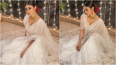 Mouni Roy, dressed in a pristine white organza lehenga set, is the perfect Navratri outfit inspiration for those who love to keep things minimal yet elegant. Complete the look with golden jewellery and a rose in your hair for a charming touch. (Instagram/@imouniroy) Mouni Roy, dressed in a pristine white organza lehenga set, is the perfect Navratri outfit inspiration for those who love to keep things minimal yet elegant. Complete the look with golden jewellery and a rose in your hair for a charming touch. (Instagram/@imouniroy)