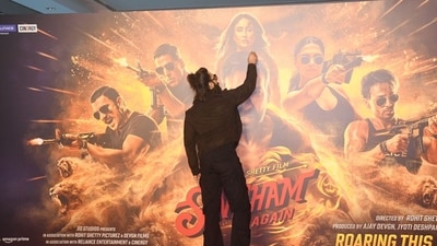 Ranveer Singh admires the poster for Singham Again at the trailer launch in Mumbai. His wife actor Deepika Padukone is also part of the movie but wasn't part of the launch. Ranveer Singh admires the poster for Singham Again at the trailer launch in Mumbai. His wife actor Deepika Padukone is also part of the movie but wasn't part of the launch.