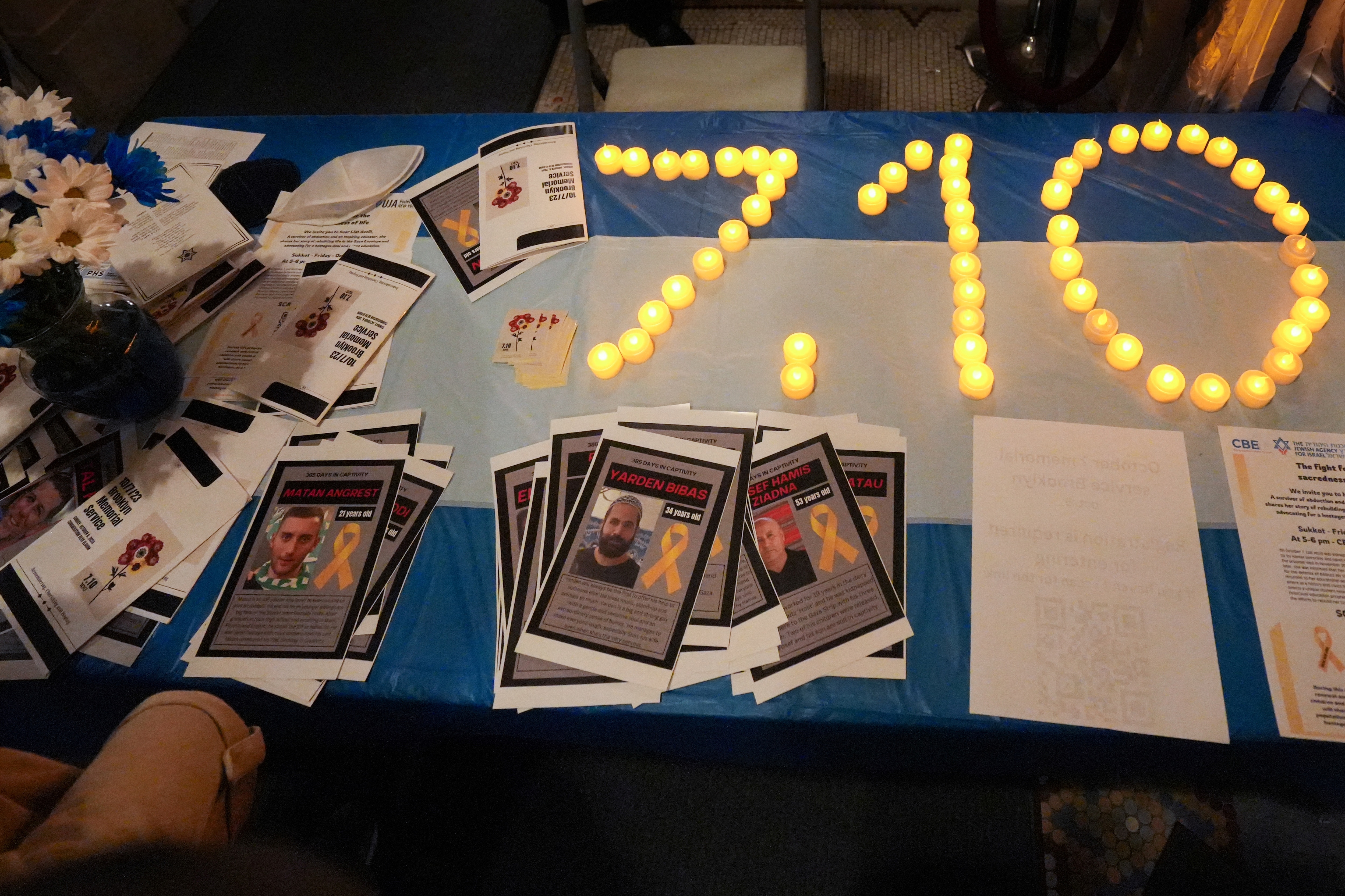 Flyers featuring pictures of hostages kidnapped during the October 7, 2023 attack on Israel by Hamas are placed on a table during a mourning prayer service at Congregation Beth Elohim nearly one year after the attack, in the Brooklyn borough of New York City, U.S. October 6, 2024.  REUTERS/Stephani Spindel (REUTERS)